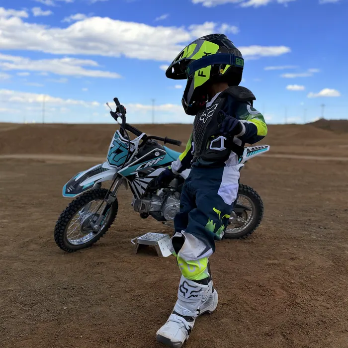 Kapakū standing with his bike